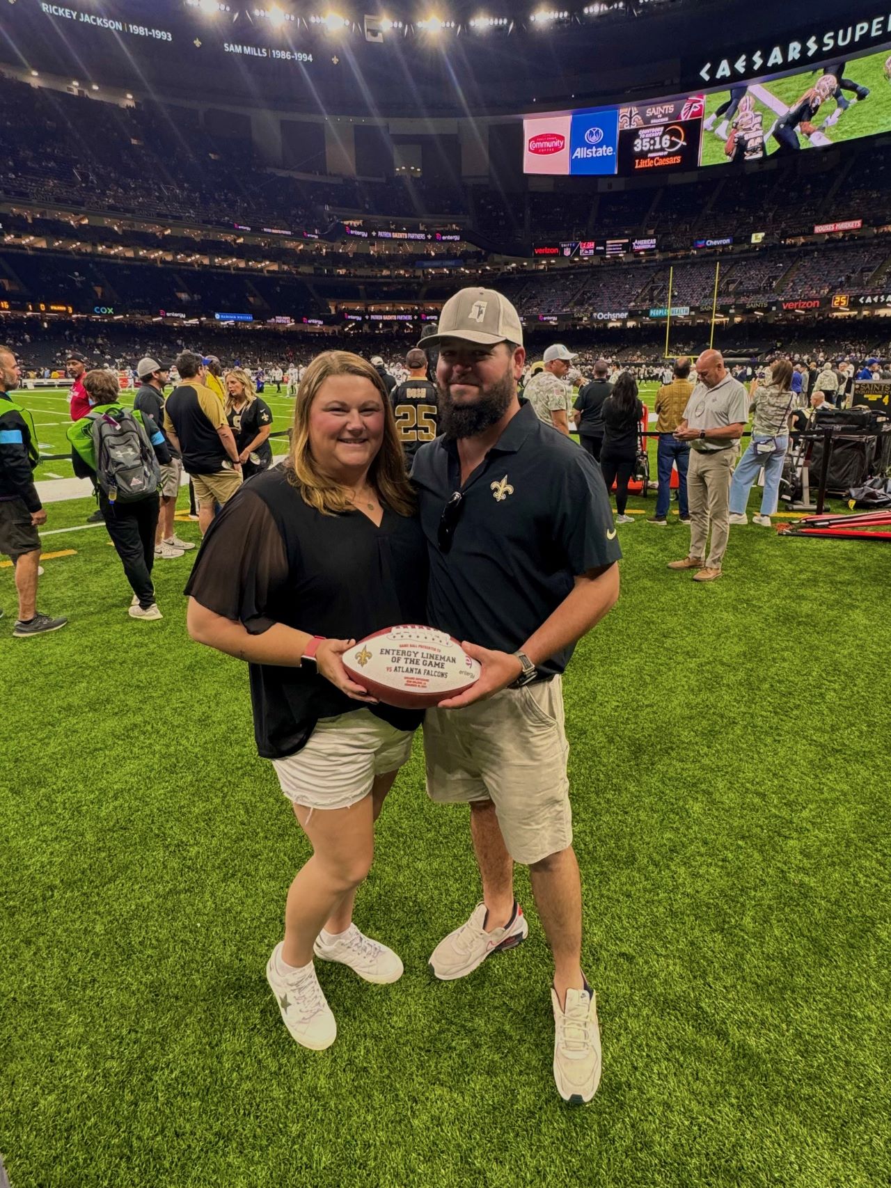 Mcadory and wife pose on the sidelines during the VIP pregame activities. 